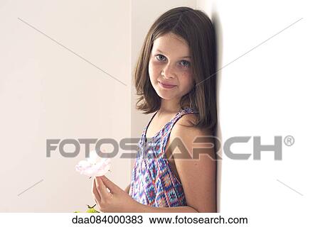 Stock Image - Girl holding rose, portrait. Fotosearch