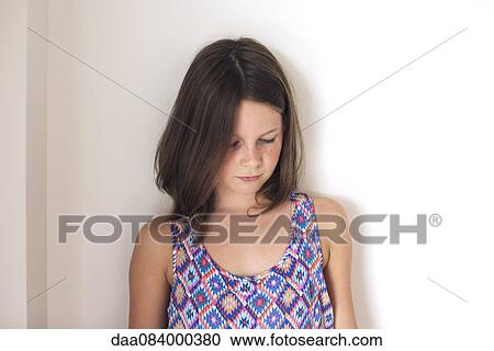 Stock Image - Girl looking down, portrait. Fotosearch