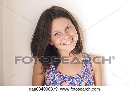 Stock Photo - Girl smiling cheerfully, portrait. Fotosearch