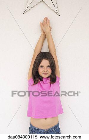 Stock Photography - Girl with arms raised in the air, portrait. Fotosearch