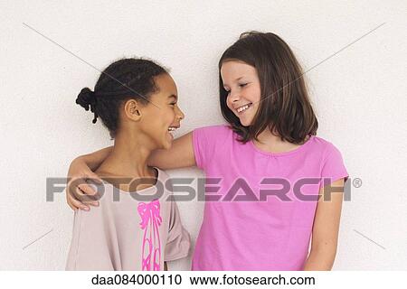 Girls chatting and smiling together View Large Photo Image Stock Image - Girls chatting and smiling together. Fotosearch