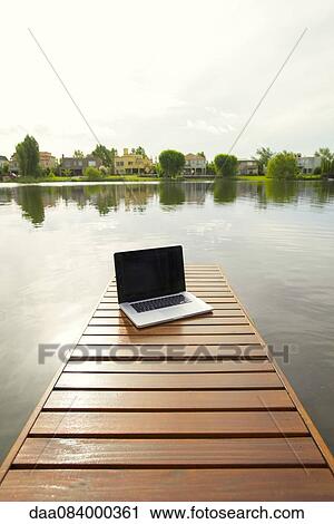 Laptop computer on lake pier View Large Photo Image Stock Image - Laptop computer on lake pier. Fotosearch