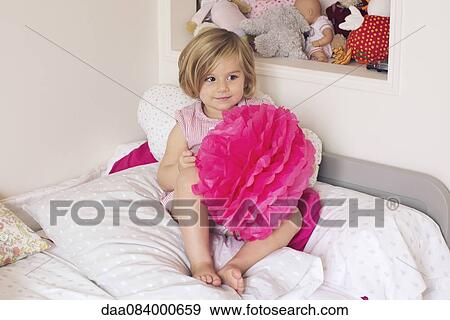 Stock Photo - Little girl holding tissue paper pompom. Fotosearch