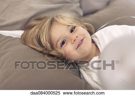 Stock Photography - Little girl relaxing at home. Fotosearch