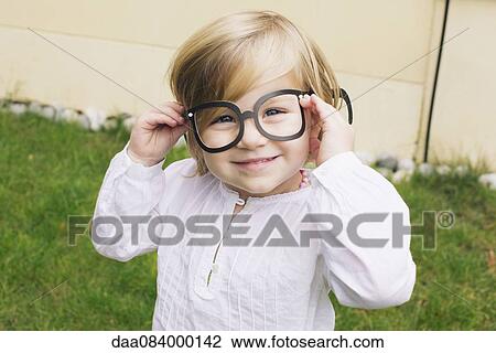 Little girl wearing costume glasses View Large Photo Image Stock Image - Little girl wearing costume glasses. Fotosearch