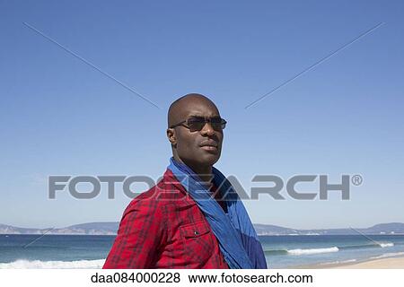 Man at the beach, looking away in thought, portrait View Large Photo Image Stock Photo - Man at the beach, looking away in thought, portrait. Fotosearch