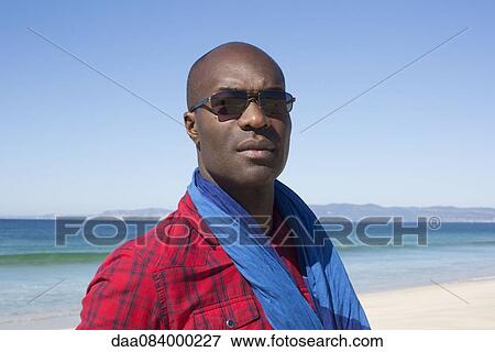 Stock Photo - Man at the beach, portrait. Fotosearch