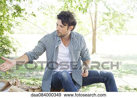 Stock Photo - Man gesturing to person out-of-frame. Fotosearch