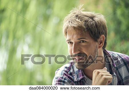 Man looking away in thought, portrait View Large Photo Image Stock Image - Man looking away in thought, portrait. Fotosearch