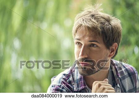 Man looking away in thought, portrait View Large Photo Image Stock Photo - Man looking away in thought, portrait. Fotosearch