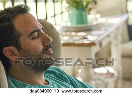 Man napping in armchair View Large Photo Image Stock Image - Man napping in armchair. Fotosearch