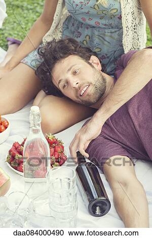 Man relaxing with companion at picnic View Large Photo Image Stock Image - Man relaxing with companion at picnic. Fotosearch