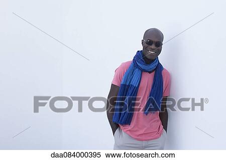 Man wearing scarf and sunglasses, smiling, portrait View Large Photo Image Stock Photography - Man wearing scarf and sunglasses, smiling, portrait. Fotosearch