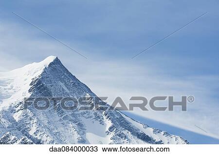 Snow-covered mountain peak View Large Photo Image Stock Image - Snow-covered mountain peak. Fotosearch