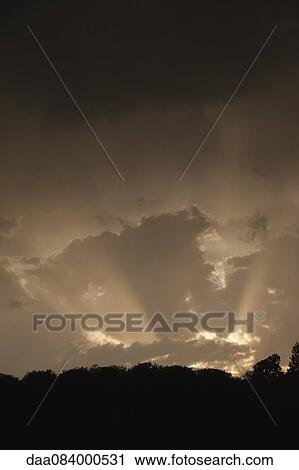 Stock Image - Sunbeam through clouds. Fotosearch