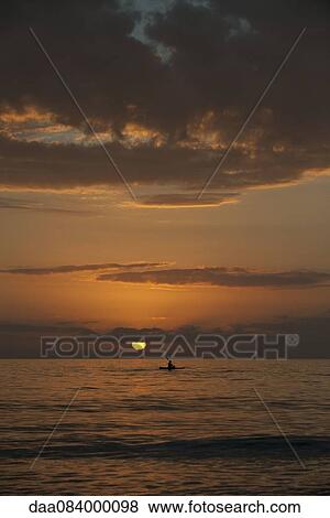Stock Photo - Tranquil sunset over ocean. Fotosearch