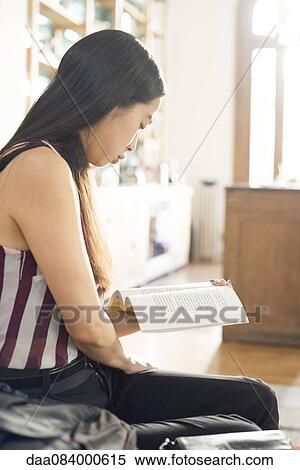 Woman at home reading book View Large Photo Image Stock Photography - Woman at home reading book. Fotosearch
