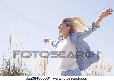 Woman enjoying fresh air outdoors View Large Photo Image Stock Image - Woman enjoying fresh air outdoors. Fotosearch