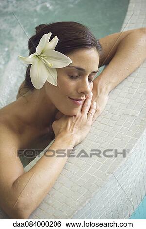 Woman in pool, resting head on arms View Large Photo Image Stock Photograph - Woman in pool, resting head on arms. Fotosearch