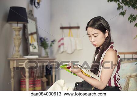 Woman reading novel at home View Large Photo Image Stock Image - Woman reading novel at home. Fotosearch