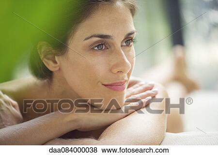Woman reclining on lounge chair View Large Photo Image Stock Photo - Woman reclining on lounge chair. Fotosearch