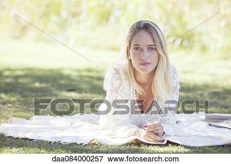 Woman relaxing in park View Large Photo Image Stock Photo - Woman relaxing in park. Fotosearch