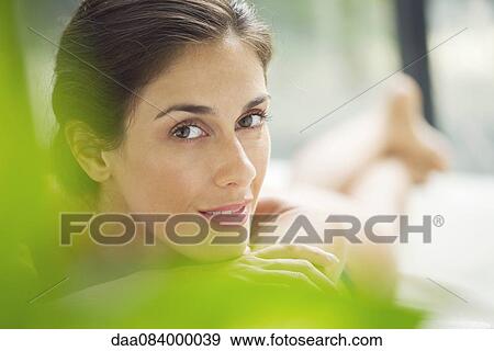 Stock Photo - Woman relaxing on lounge chair. Fotosearch