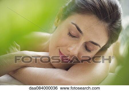 Woman resting head on arms View Large Photo Image Stock Photograph - Woman resting head on arms. Fotosearch