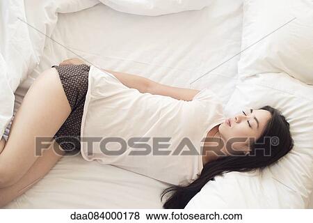 Woman sleeping alone View Large Photo Image Stock Photo - Woman sleeping alone. Fotosearch