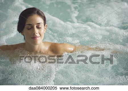 Stock Photography - Woman soaking in spa pool. Fotosearch