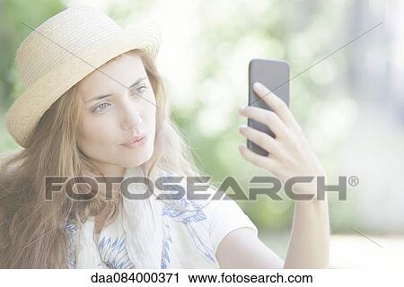 Woman taking selfie with smartphone View Large Photo Image Stock Image - Woman taking selfie with smartphone. Fotosearch
