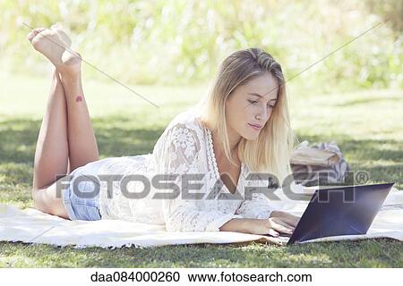 Woman using netbook outdoors View Large Photo Image Stock Image - Woman using netbook outdoors. Fotosearch