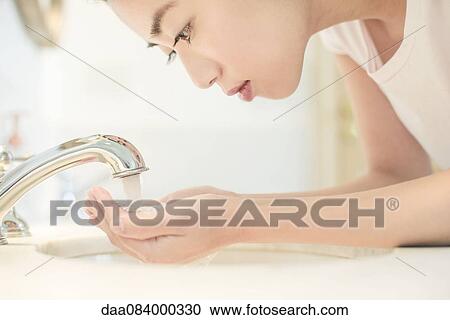 Woman washing face View Large Photo Image Stock Image - Woman washing face. Fotosearch