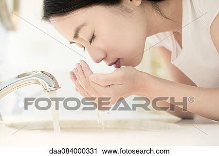 Stock Image - Woman washing face. Fotosearch