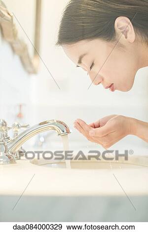 Stock Photo - Woman washing face. Fotosearch