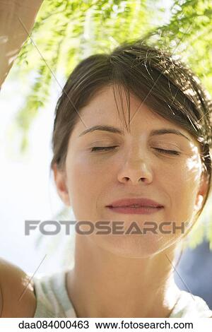 Woman with eyes closed outdoors, portrait View Large Photo Image Stock Image - Woman with eyes closed outdoors, portrait. Fotosearch