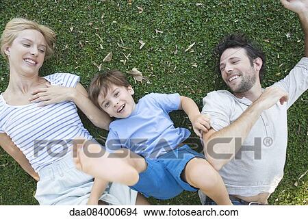 Picture - Young family enjoying carefree afternoon playing together. Fotosearch