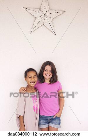 Young friends smiling together, portrait View Large Photo Image Stock Image - Young friends smiling together, portrait. Fotosearch