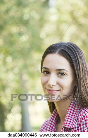 Stock Photograph - Young woman smiling, portrait. Fotosearch