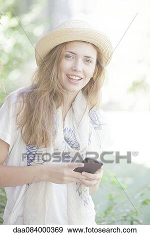 Young woman using smartphone, portrait View Large Photo Image Stock Photo - Young woman using smartphone, portrait. Fotosearch