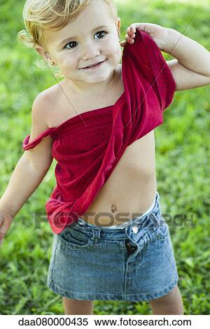Stock Photography - Baby girl lifting shirt up, portrait. Fotosearch