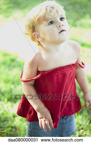 Stock Image - Baby girl looking up, portrait. Fotosearch