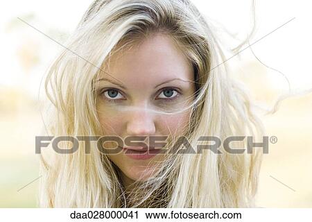 Blonde Woman With Hair Tousled Looking At Camera Stock Image