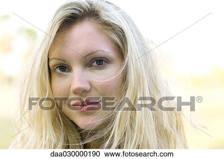 Blonde woman with tousled hair smiling at camera View Large Photo Image Stock Image - Blonde woman with tousled hair smiling at camera. Fotosearch