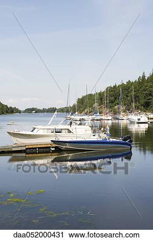 Boats docked in lake marina View Large Photo Image Stock Image - Boats docked in lake marina. Fotosearch