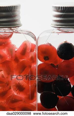 Bottles containing fresh berries and pomegranate seeds, close-up View Large Photo Image Stock Photo - Bottles containing fresh berries and pomegranate seeds, close-up. Fotosearch