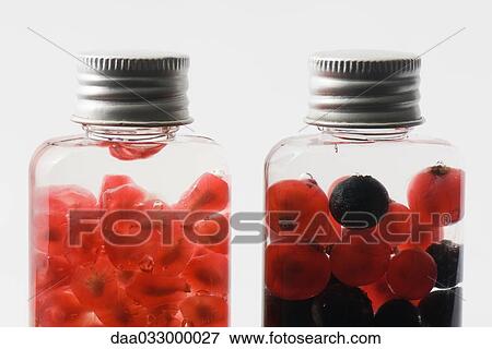 Bottles containing fresh berries and pomegranate seeds, close-up View Large Photo Image Stock Photo - Bottles containing fresh berries and pomegranate seeds, close-up. Fotosearch