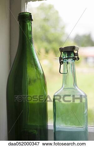 Bottles set in windowsill View Large Photo Image Stock Photo - Bottles set in windowsill. Fotosearch