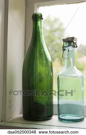 Bottles set in windowsill View Large Photo Image Stock Photo - Bottles set in windowsill. Fotosearch