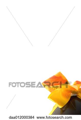 Bow on chocolate egg, partial view View Large Photo Image Picture - Bow on chocolate egg, partial view. Fotosearch